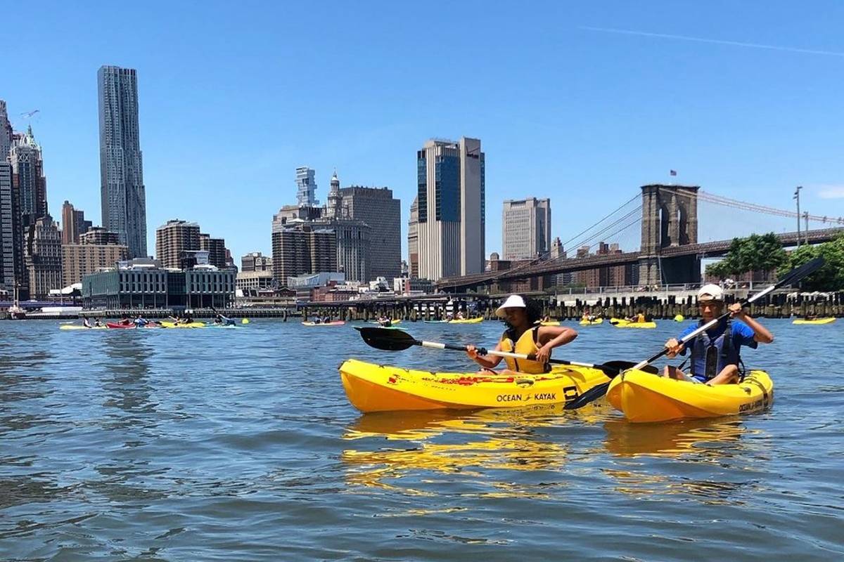 Brooklyn Bridge Park kayaking program; two yellow boats with the Brooklyn Bridge and NYC skyline in the background