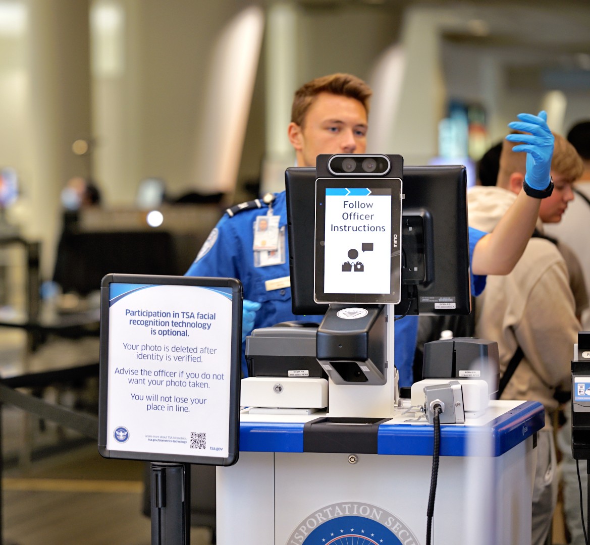 TSO behind a facial recognition scanner at the airport