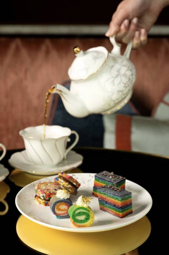 Pride High Tea with a tea cup and rainbow desserts at Courtesy: Nubeluz by José Andrés