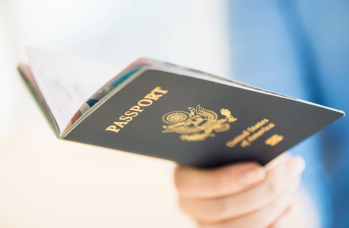 A woman holding her U.S. passport