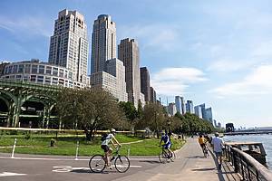 New York, New York / USA - August 1 2020: People Biking and Walking on the Riverfront trail at Riverside Park on the Upper West Side of New York City during Summer