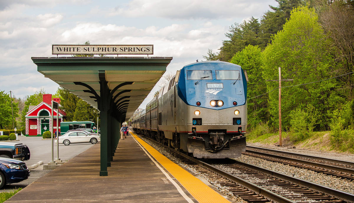 Amtrak train at a station during the spring