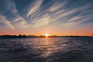 Lake Erie with active current. Sunset on the lake textured sky with spindrift clouds