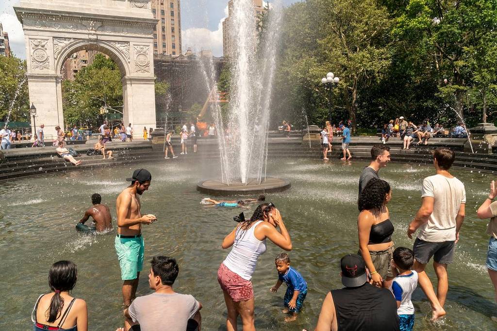 New York NY/USA - 20 juli 2019 New Yorkers en bezoekers dartelen bij de fontein in Washington Square Park in Greenwich Village in New York.