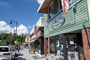 Lake Placid, USA - July 6, 2024. Street view of Lake Placid in Summer with people walking on sidewalk, New York, USA