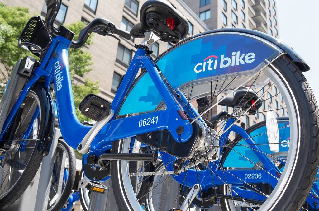 Citi Bike public sharing bicycle station with bikes ready to be rented to customer.