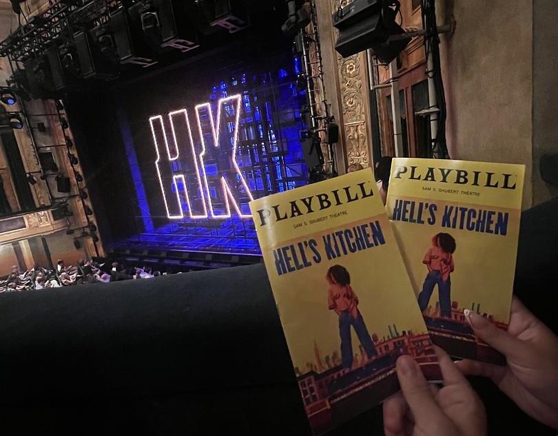 People holding Playbooks infront of the stage for Hell's Kitchen