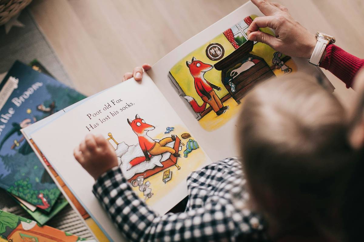 An infant looking at a children's book