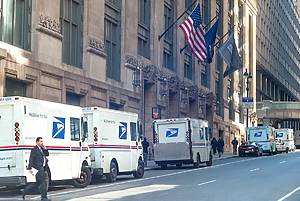 NEW YORK CITY, USA - March 25: USPS delivery trucks lined up by James A. Farley Post Office landmark building on March 25, 2008 in Midtown Manhattan, New York City, USA