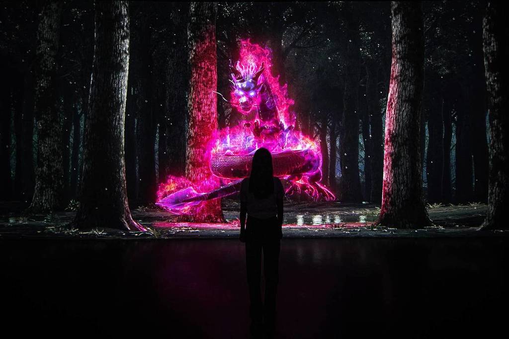 Person checking out the FOREST digital exhibit at Arte Museum New York at Chelsea Piers