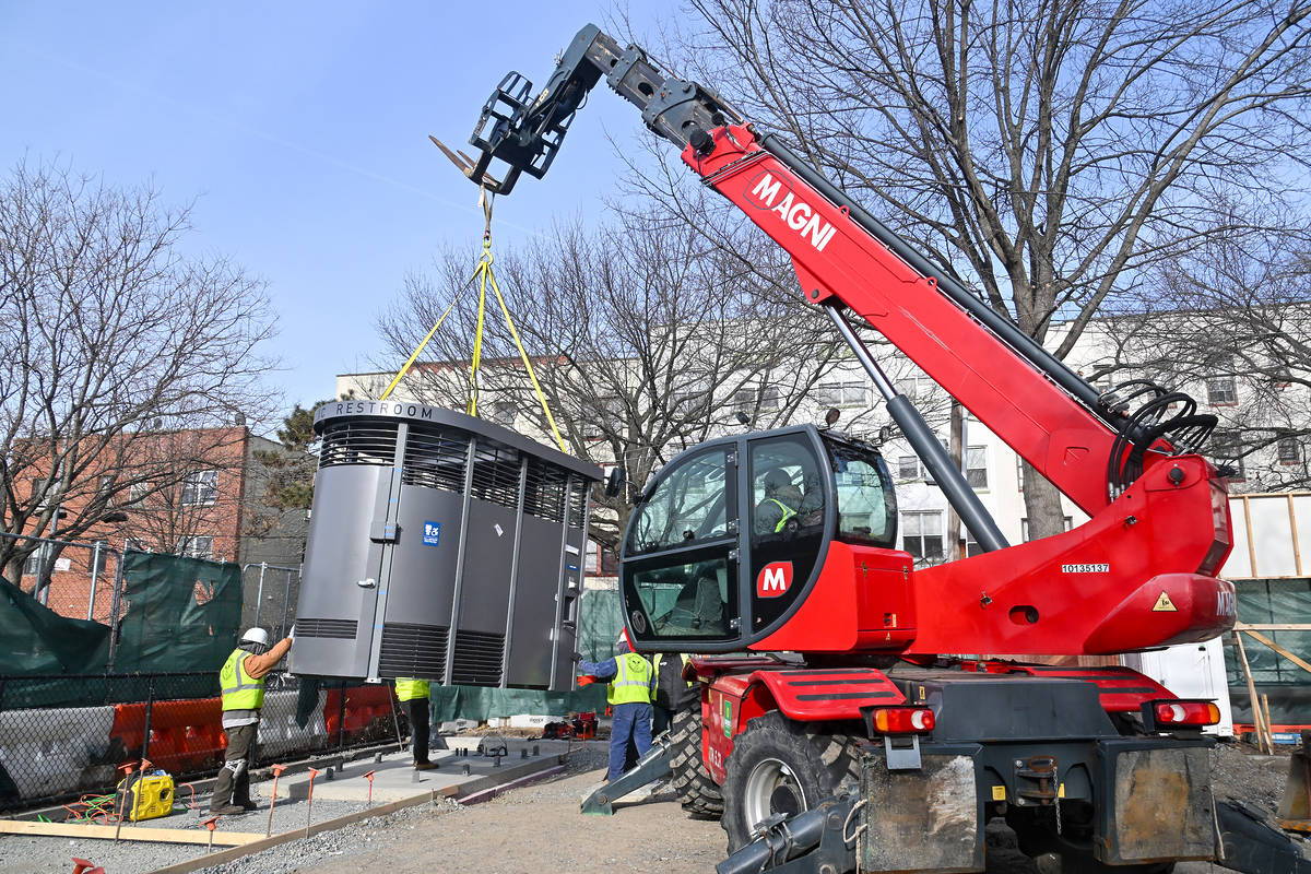 Crane installing a Portland Loo in NYC