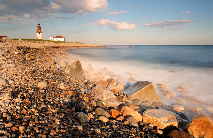 Point Judith Lighthouse at sunset at Narragansett, RI, USA. The lighthouse is located on the west side of the entrance to Narragansett Bay. Slow motion of water was applied.