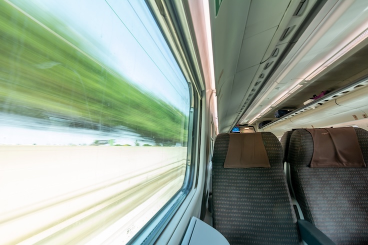 View of a Window scrolling the Landscape inside High Speed Train on Blurred Background