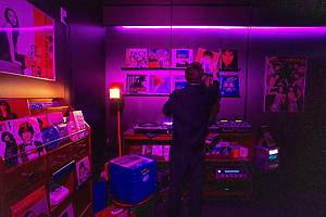 person in front of a wall of vinyls