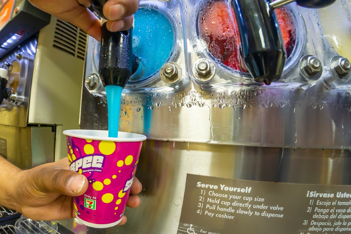 A man pouring a Slurpee into a cup