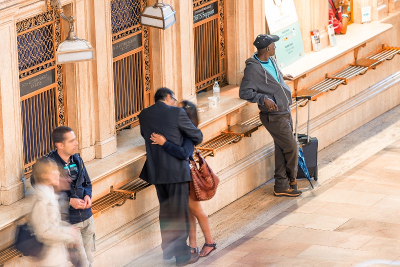 Two people kissing in Grand Central Terminal