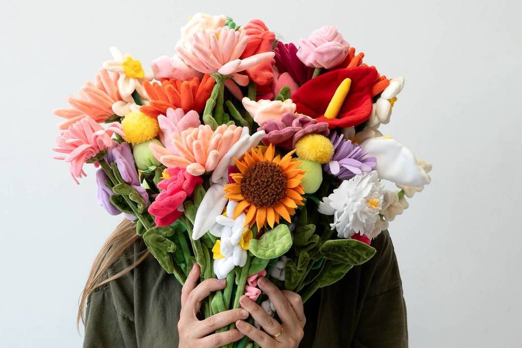 cj hendry flower market felt flowers in a bouquet held up to her face