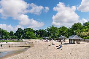 Old Greenwich, CT, USA-August 2020: Panoramic view over the beach of Greenwich Point Park or Tods Point with number of people enjoying the beach and sun