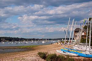 Greenwich, CT, USA June 29 Small catamarans and sailboats are lined up on the beach in a pattern or row on a summer day in Greenwich, Connecticut