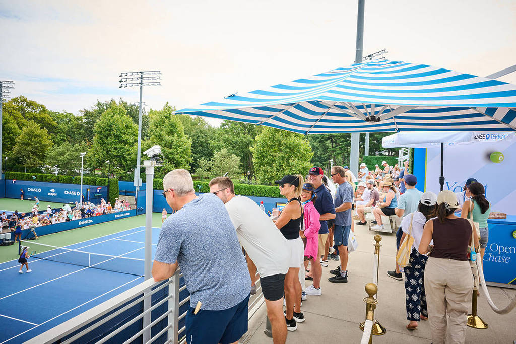 Spectators watching a tennis game from the Chase Terrace.