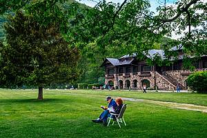 A couple reads in an open field in Bear Mountain State Park in New York.
