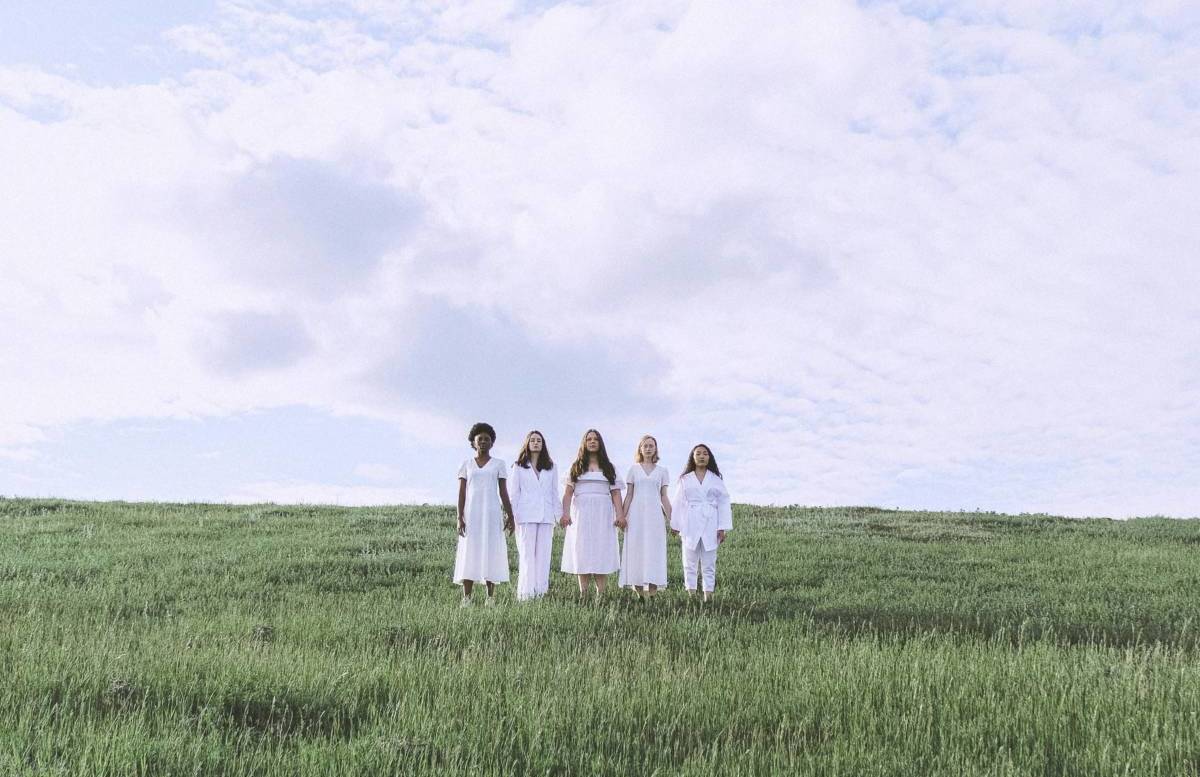 Women in afield wearing white