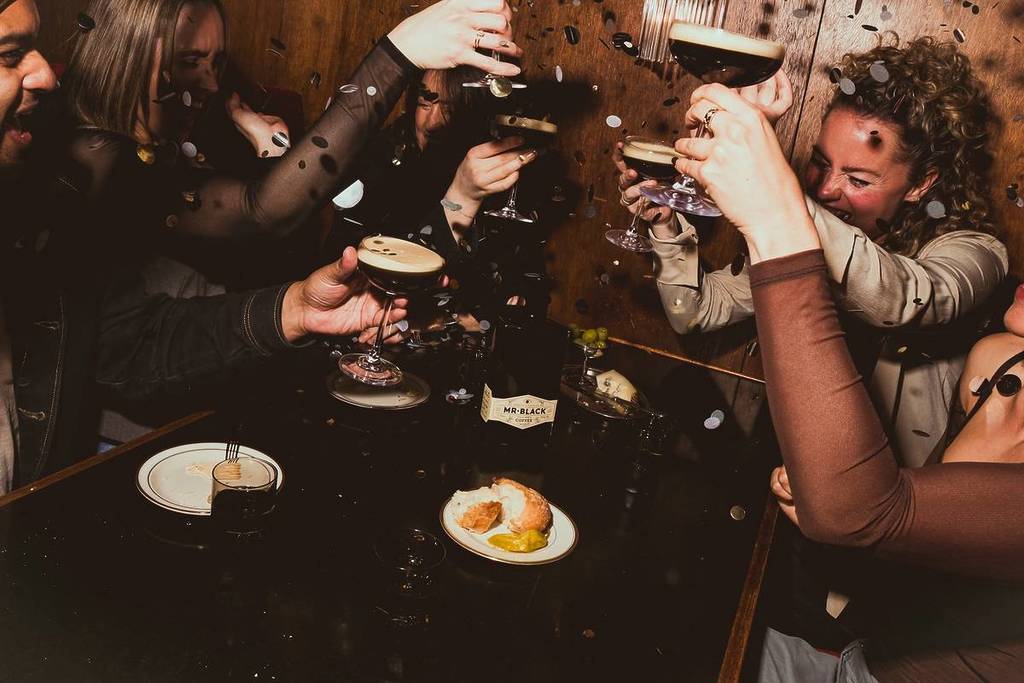 A group of people enjoying Espresso Martinis around a table