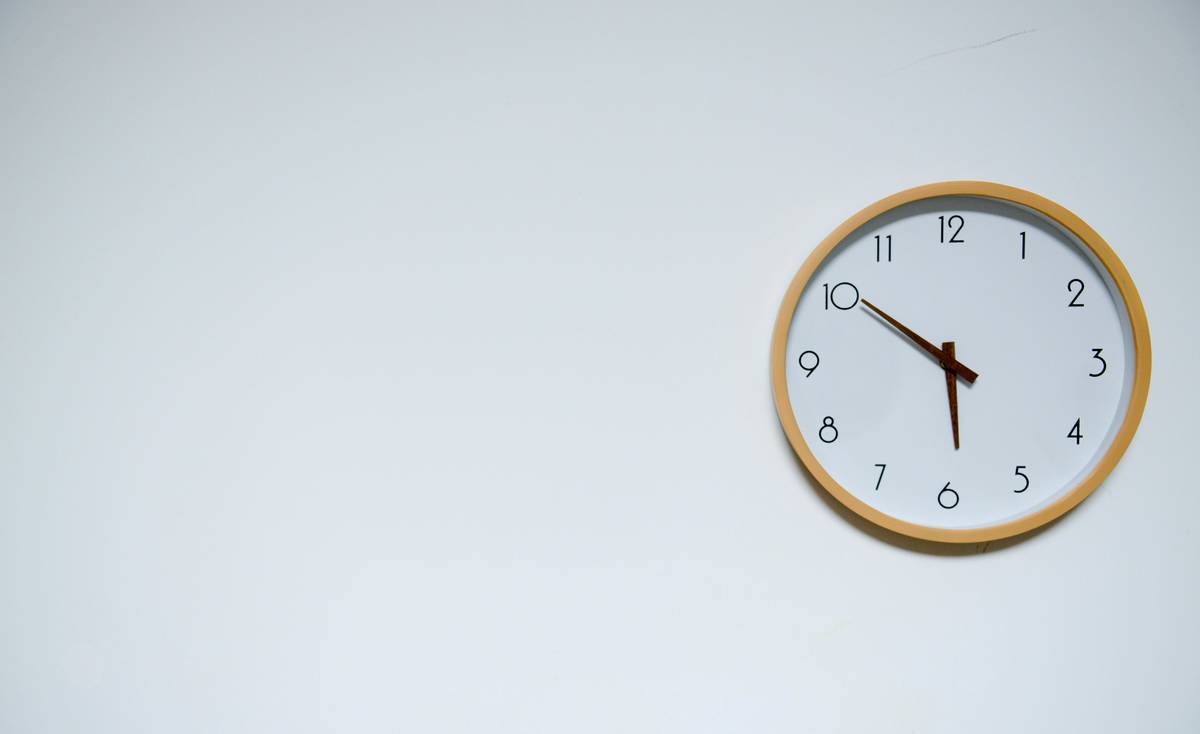 A clock mounted on a white wall