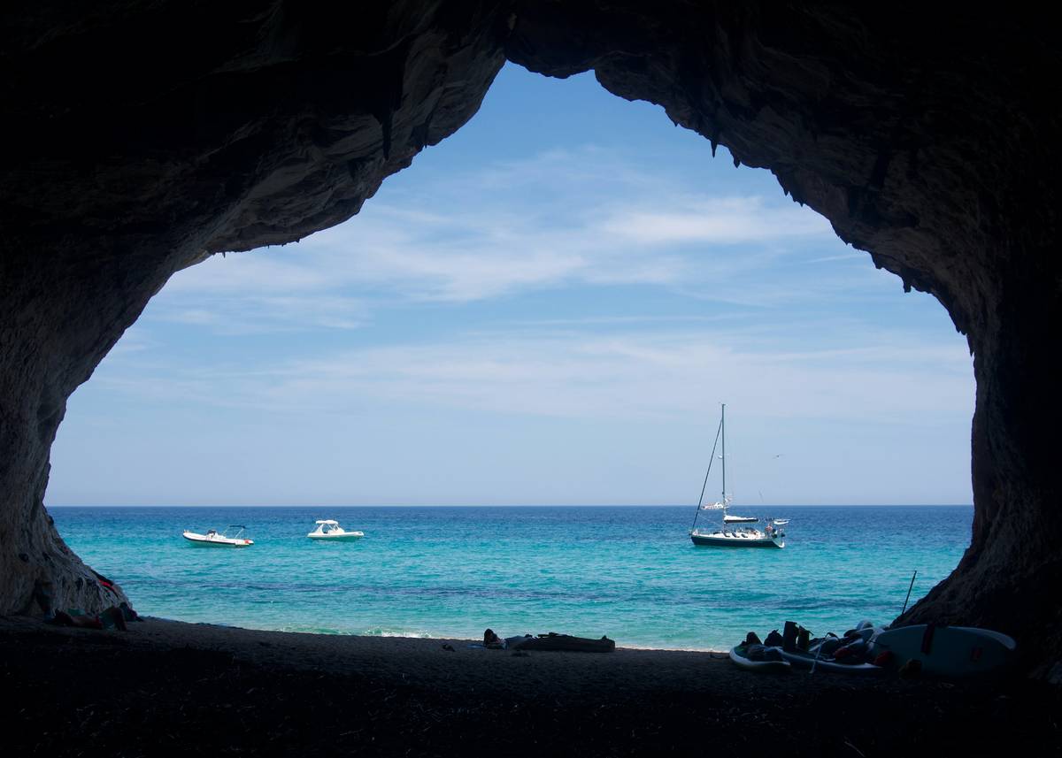 View of water through cave in Sardinia