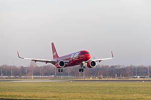 Amsterdam Schiphol Airport, the Netherlands - December 1 2024: Play budget airline airbus a320 passenger aircraft landing near bird strike prevention vehicle