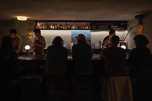 people sitting at the bar inside Smithereens