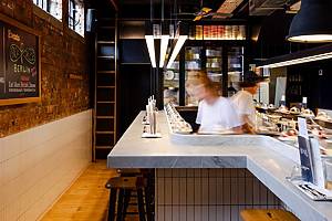 worker at Pick & Cheese, London-based cheese conveyor belt restaurant opening in Shaver Hall