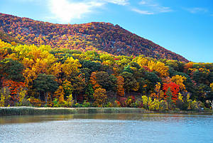 Autumn Mountain with lake view and colorful foliage in forest.