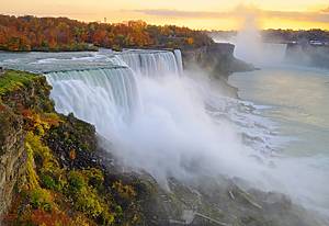 Niagara Falls at sunset, viewed from New York side. Some motion blurs from the plants may be visible due to the wind and not focus issue.