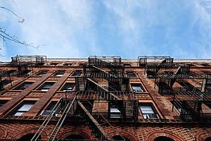 NYC apartment brick apartment building with fire escapes