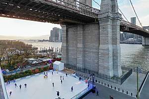people ice skating at Roebling Rink under the brooklyn bridge