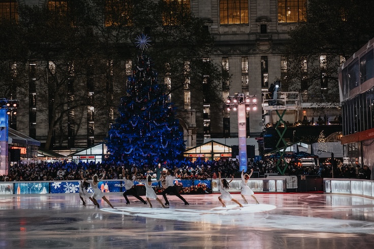Photographs of the 2024 Tree Lighting ceremony held in Bryant Park, New York City.