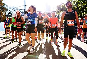 NEW YORK, NEW YORK - NOVEMBER 03: Runners react after crossing the finish line of the 2024 TCS New York City Marathon on November 03, 2024 in New York City. (Photo by Sarah Stier/Getty Images)