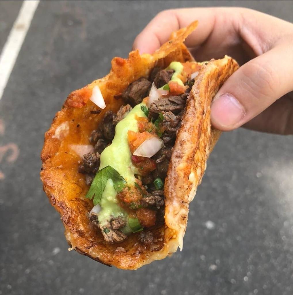 Taco in hand from Los Tacos No1 in NYC