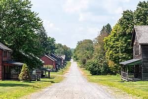Hazelton, Pennsylvania - August 6, 2021: Old wooden buildings, rail tracks and coal breaker in the historic Eckley Miners Village in Pennsylvania.