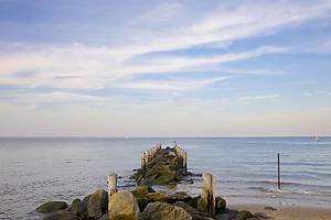 Pier extending into Long Island Sound below cirrus clouds, Sands Point, Nassau County, Long Island, New York, USA.