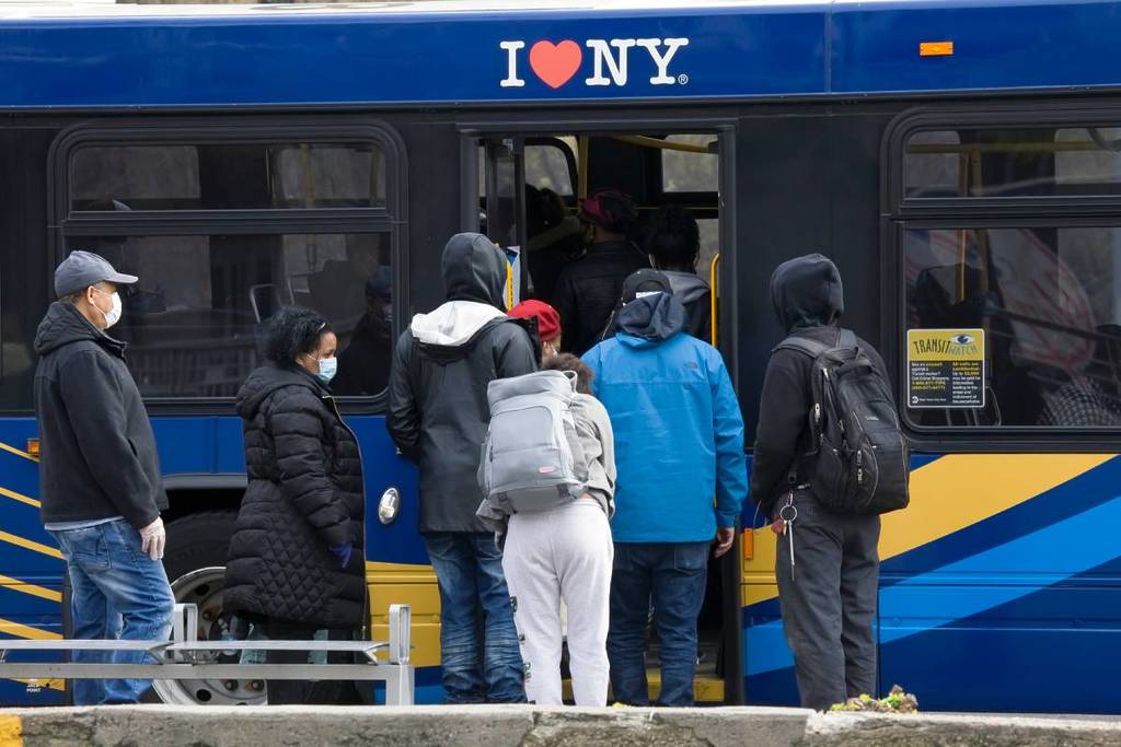 people boarding an MTA bus in NYC