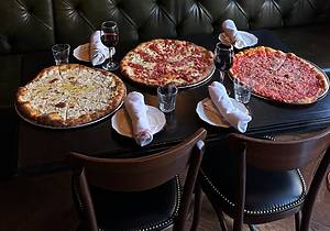 pizza and wine on a table at Lucky Charlie