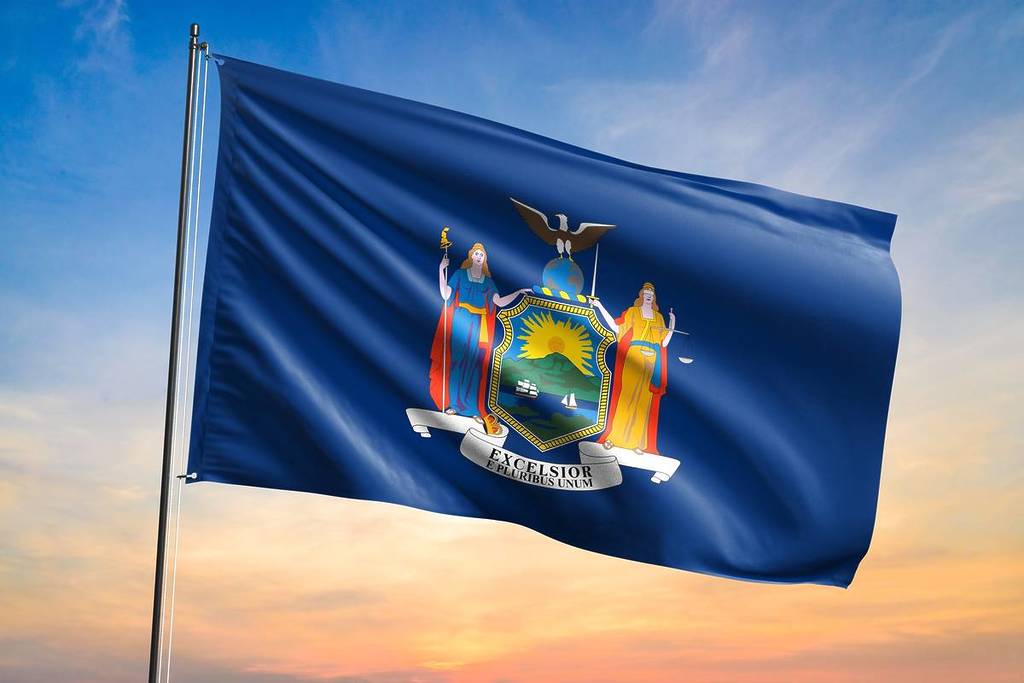 Bandeira de Nova York tremulando na vista do pôr do sol