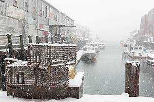 Lobster traps on a commercial pier during a snowstorm in Maine