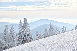 Panoramic view to the ski slopes with fresh snow from the Octagon cafe observation deck at peak Mansfield 4393 ft summit - Stowe Ski resort, VT