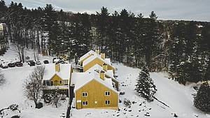 yellow house in the snow in Stowe, Vermont