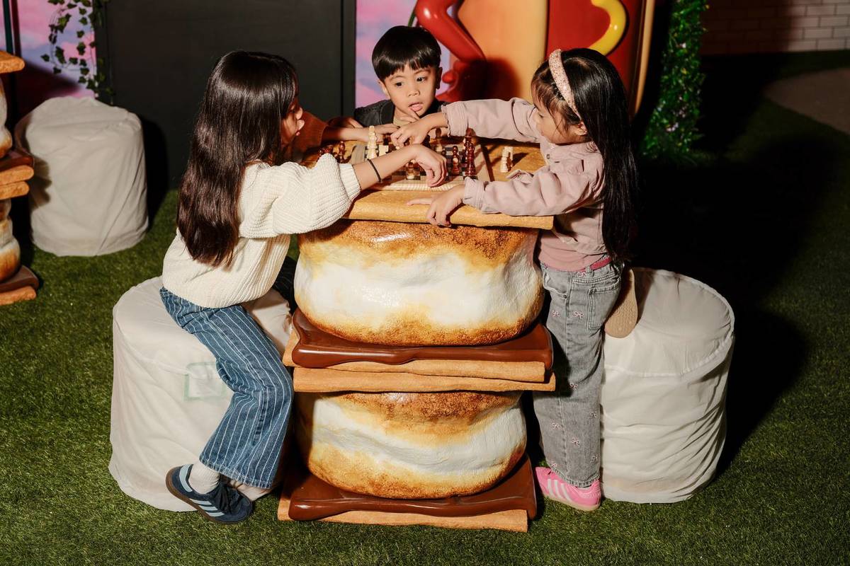 children playing chess at s'mores table