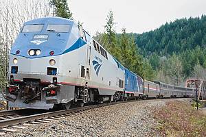 Index, WA, USA - January 16, 2023; Amtrak Empire Builder sleeper train travelling around a bend in winter