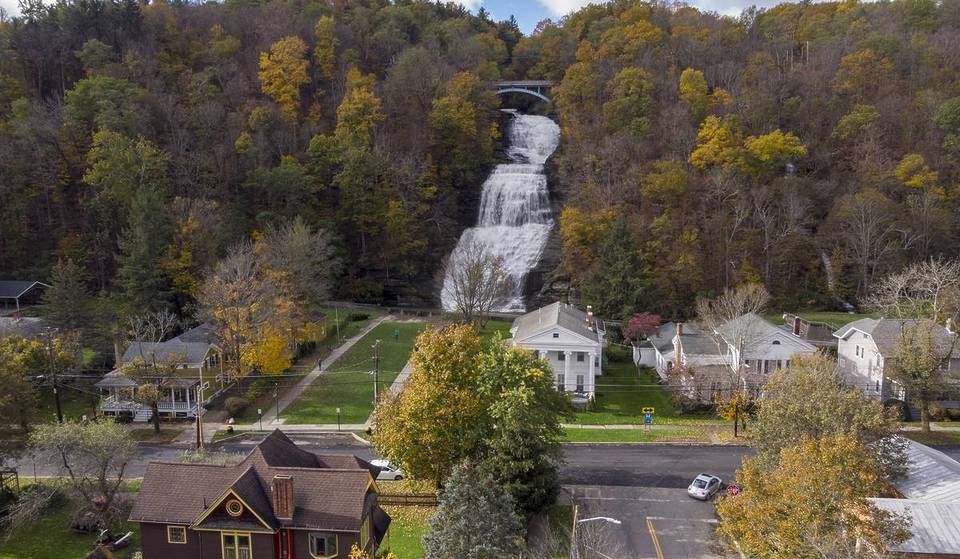 This Tiny NY Village Sits In The ‘Valley of Tumbling Waters’ — With A Charming Main Street That Ends At A 156-Foot Waterfall